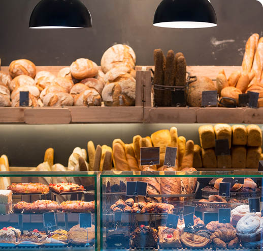 Modern bakery with different kinds of bread, cakes and buns 