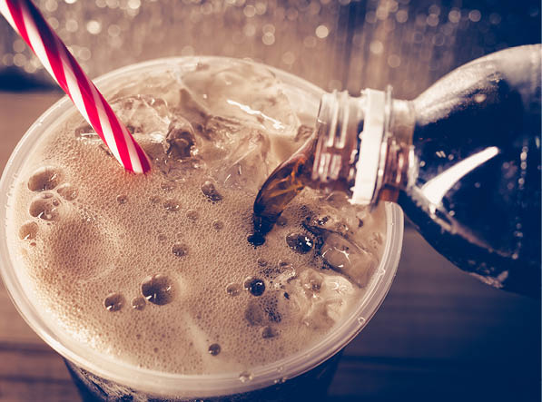 Refreshing Bubbly Soda Pop with Ice Cubes. Cold soda iced drink in a glasses - Selective focus, shallow DOF.