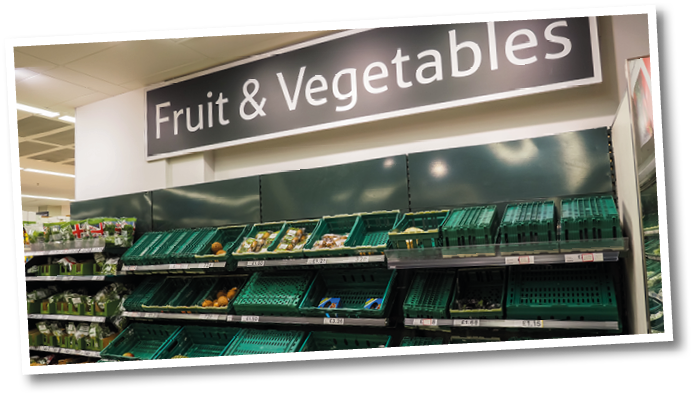 London, Bishopgate, UK. April 24th 2020: Tesco Bishopgate branch, showing low stocks of fruit and vegetables on shelves. Upturned green container baskets. Food shortages, inflation and cost of living.