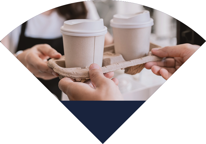 Close up woman hands gives paper coffee cup on slide glass window. Take away delivery concept. Asian woman barista. Cropped shot of waitress and buyer hold coffee, eco recycle environment friendly.