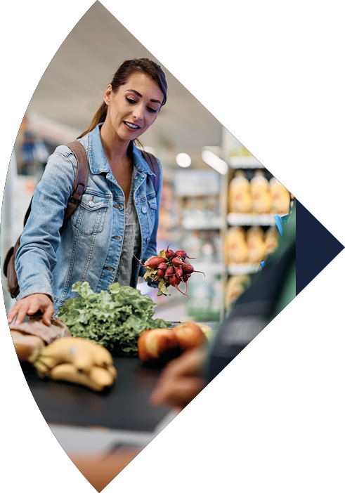 Female supermarket customer paying for goods at the checkout.