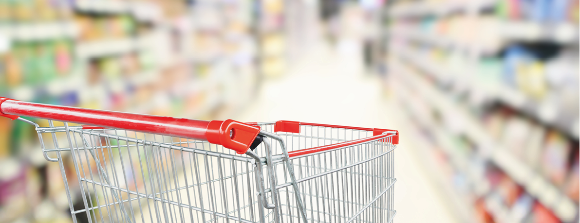 empty red shopping cart in supermarket aisle