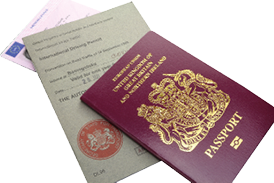 CAMBRIDGE, UK - JULY 14, 2016: United Kingdom or British EU Passport with International Driving Permit and Driving Licence - illustrative editorial