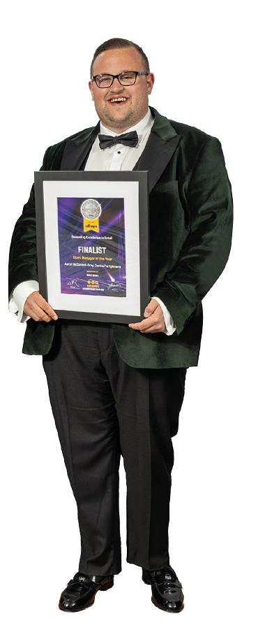 A man in a suit and bow tie holds a framed award. AI generated content