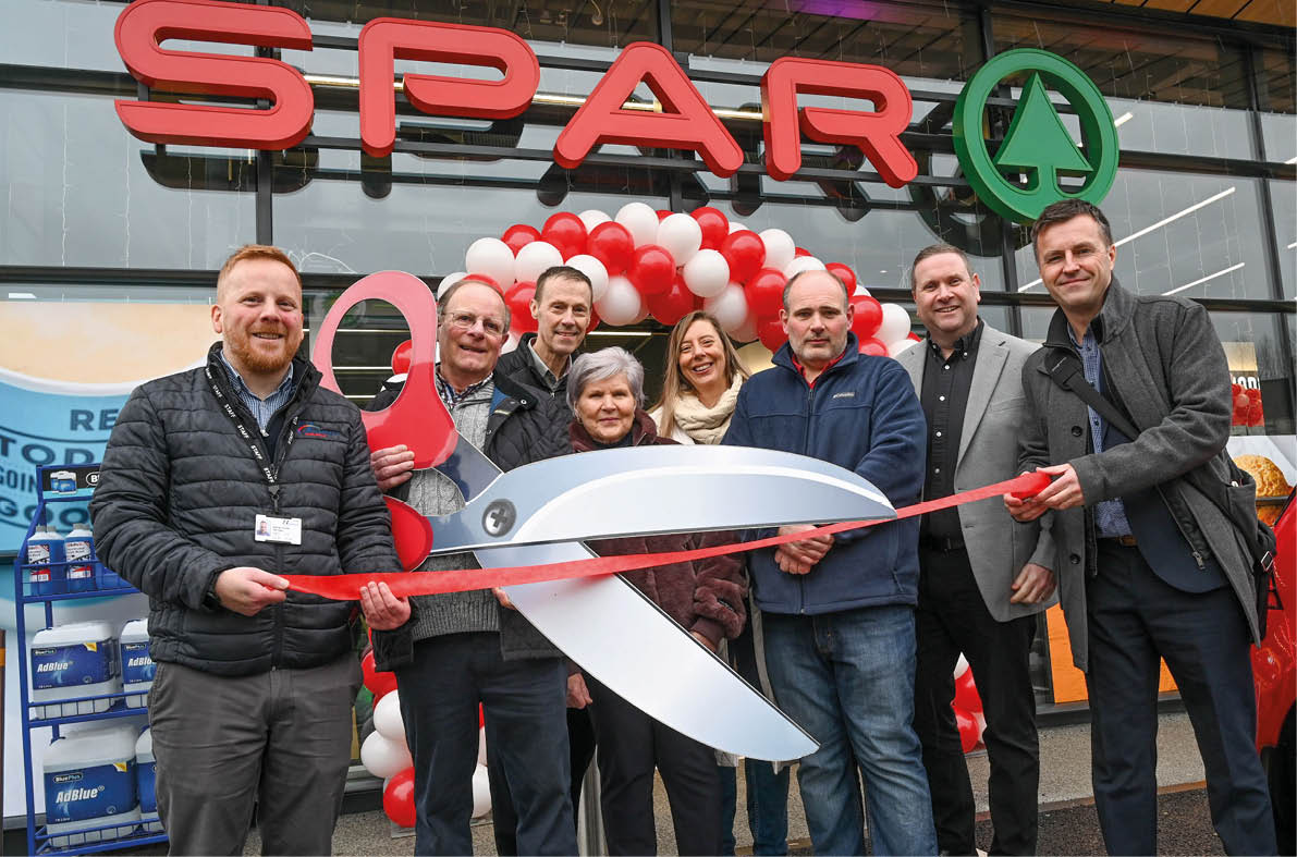 A group of people are standing in front of a store, holding a pair of scissors and a large red ribbon. They are posing for a photo, possibly to celebrate the opening of a new store or a special event. AI generated content
