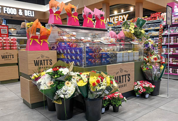 A flower shop with a variety of flowers and pink bags. AI generated content