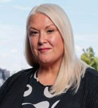 A woman with blonde hair and a black shirt is smiling for the camera. AI generated content