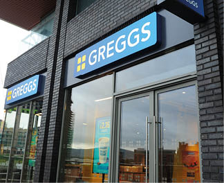 A storefront for Greggs with a blue sign. Description generated by AI