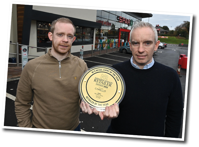 Two men holding a trophy. Description generated by AI