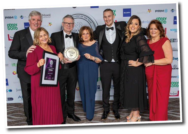 A group of people standing together. Description generated by AI