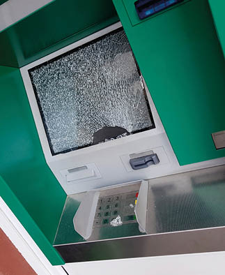 A broken ATM machine with a cracked screen. Description generated by AI