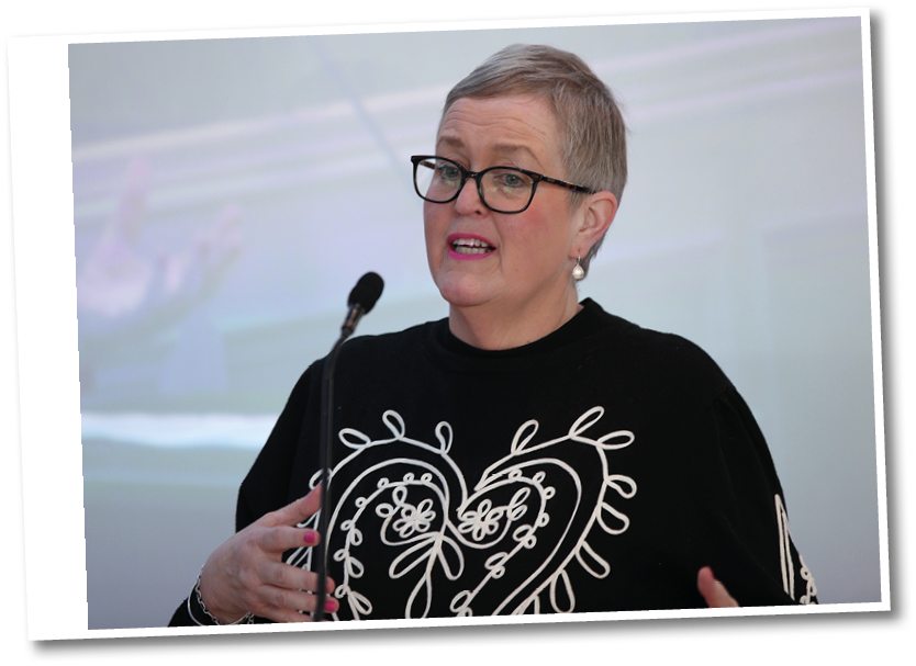 A woman wearing a black shirt with a white heart on it. Description generated by AI