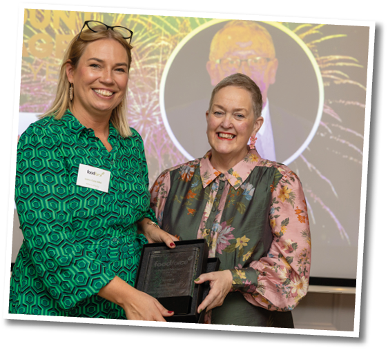 A woman holding a black box. Description generated by AI