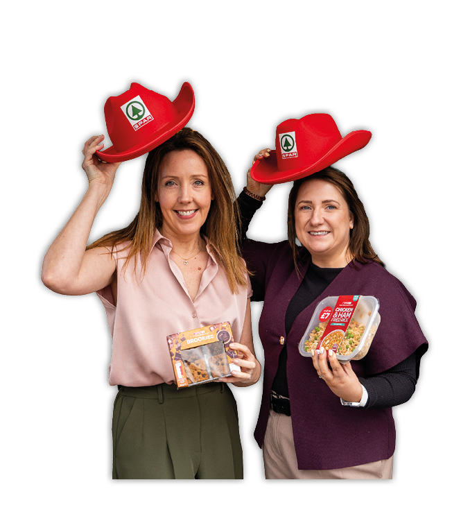 Two women wearing red cowboy hats. Description generated by AI