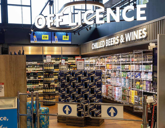 A store with a blue sign that says “Of License" and a sign that says "Cold Beers & Wines." Description generated by AI