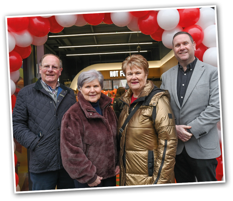 Three people pose for a picture in front of a red and white banner. AI generated content
