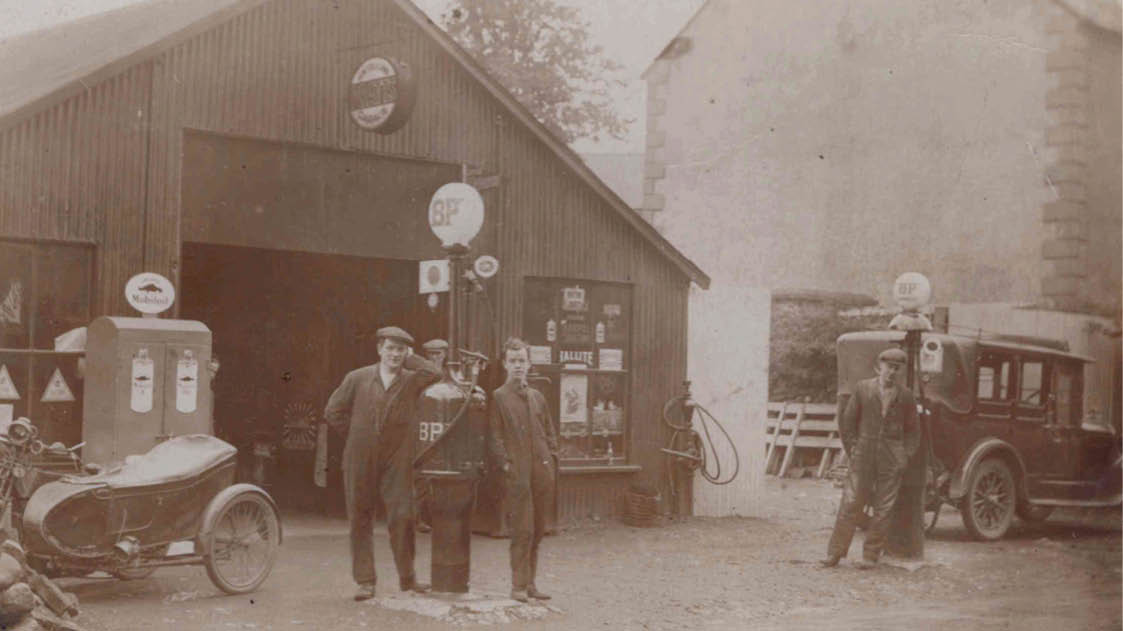 A group of men are standing outside of a gas station. AI generated content