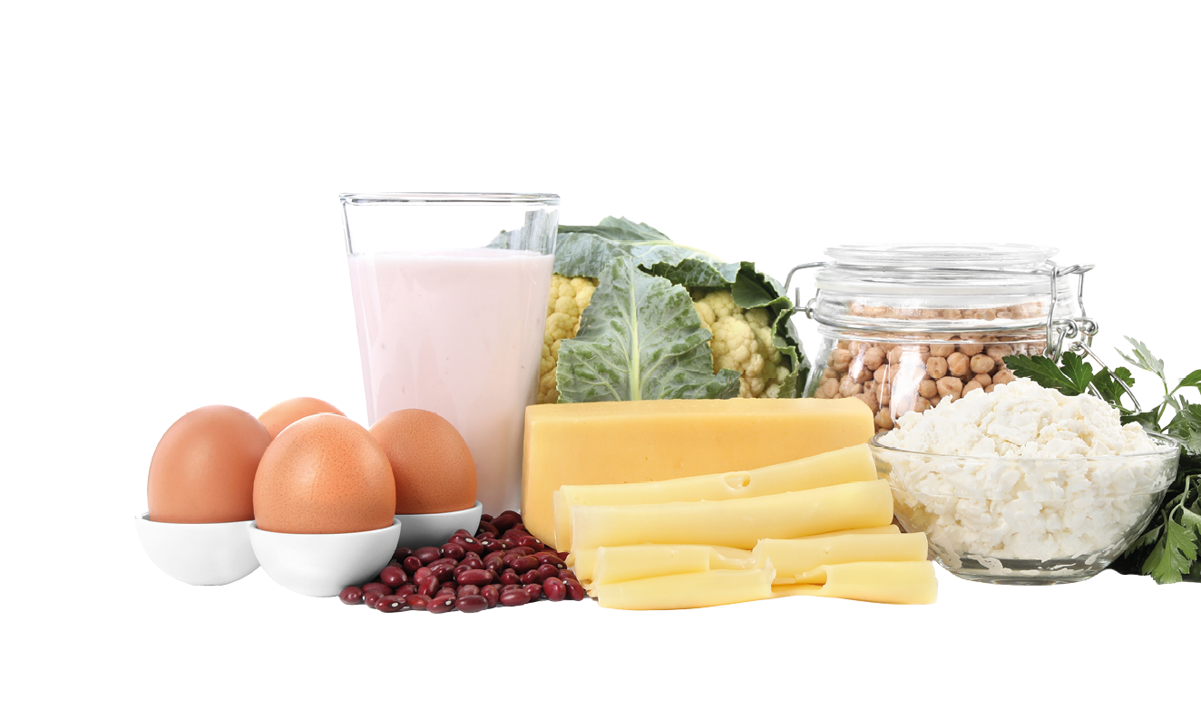 A variety of foods are displayed on a table, including eggs, milk, cheese, and rice. Description generated by AI