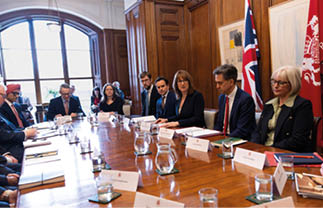 A group of people sitting around a table. Description generated by AI