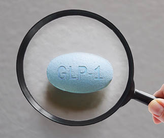 A magnifying glass is on a pill. Description generated by AI