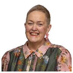 A woman with a pink shirt and earrings. Description generated by AI