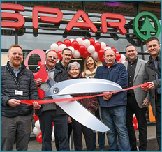 A group of people are standing in front of a store. Description generated by AI