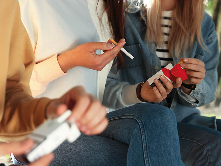 A woman is smoking a cigarette. Description generated by AI