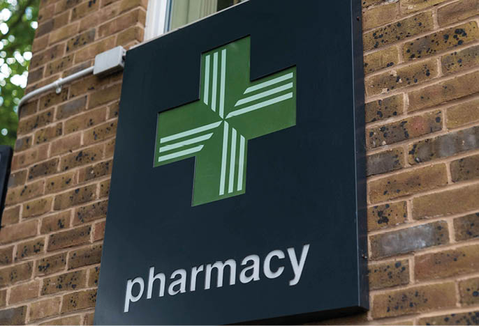 UK, London, 1/7/2020 - A close up shot of a a green cross Pharmacy logo sign