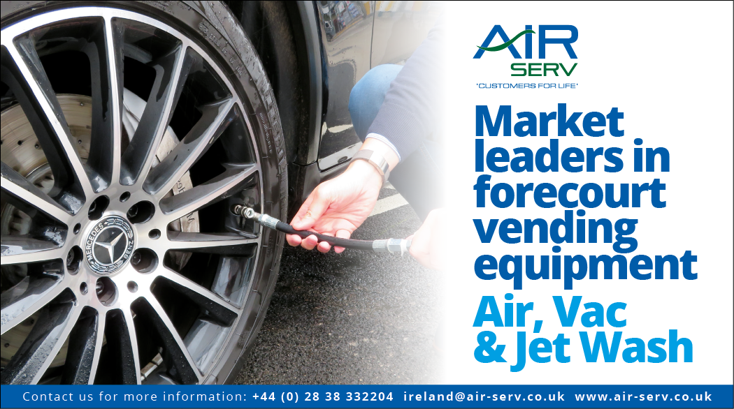 A man is putting air in a tire, while a sign advertises Air, Vac & Jet Wash. AI generated content
