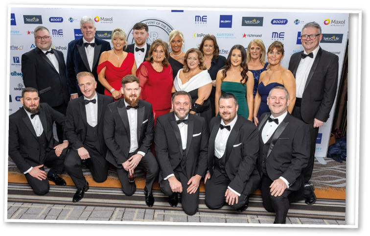 A group of people wearing tuxedos and bow ties. Description generated by AI