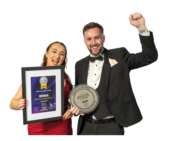 Two adults dressed in formal attire celebrate while holding an award plaque and a framed certificate. Description generated by AI