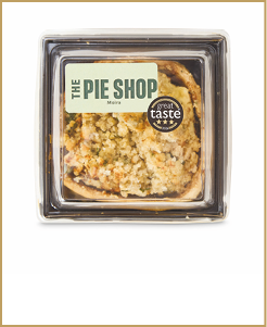 A packaged crumb-topped pie from The Pie Shop with a Great Taste award sticker on the clear plastic container. Description generated by AI