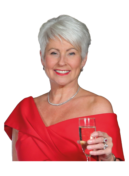 A senior person with short white hair wearing an elegant off-the-shoulder red dress and a necklace is smiling and holding a glass of champagne. Description generated by AI