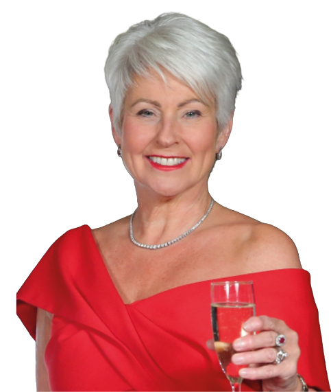 A senior person with short white hair wearing an elegant off-the-shoulder red dress is smiling and holding a glass of champagne. Description generated by AI