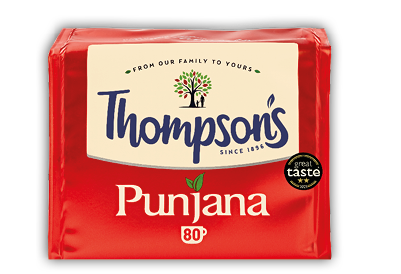 A red package of Thompson's Punjana tea with a logo featuring a tree and two people, and a Great Taste award badge. Description generated by AI
