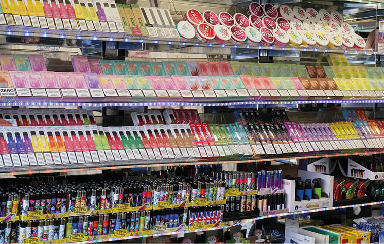 A store shelf filled with various colorful vaping products and accessories neatly arranged in rows. Description generated by AI