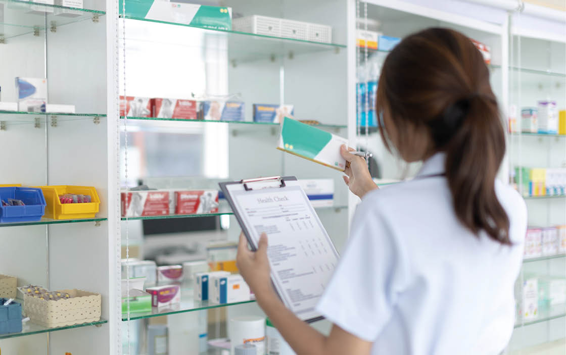 Pharmacist women are supplying prescription drugs to customers, Pharmacists work in a pharmacy, Drug store shelf with prescription medication, Clipboard at the hospital pharmacy, Community Pharmacy.