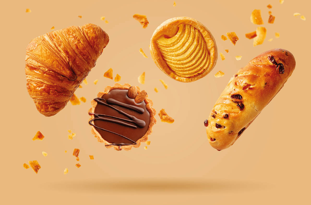 Freshly baked croissant and sweet pastries flying in air. Sweet dessert. Baked goods. 