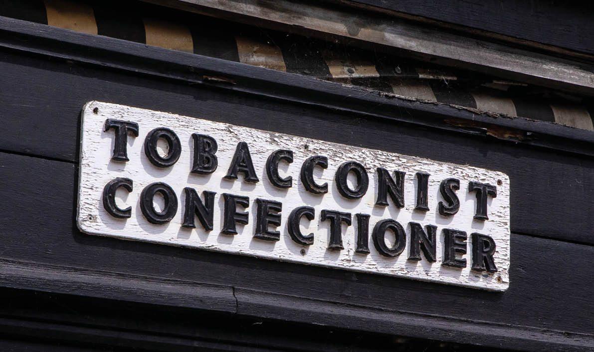 A vintage Tobacconist and Confectioner sign on the exterior of a Convenience Store in the beautiful town of Thaxted in Essex, UK.