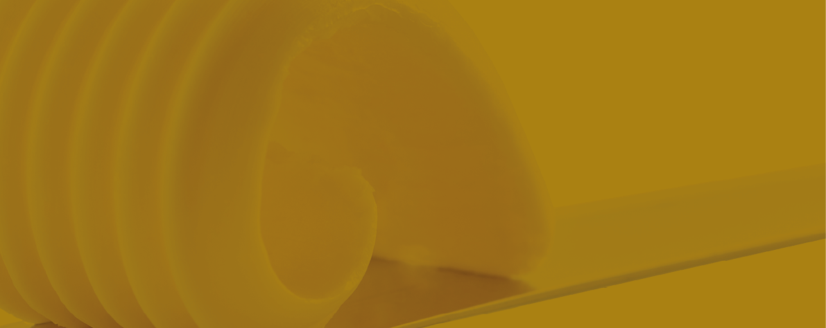 curl of fresh butter on a knife isolated on white background