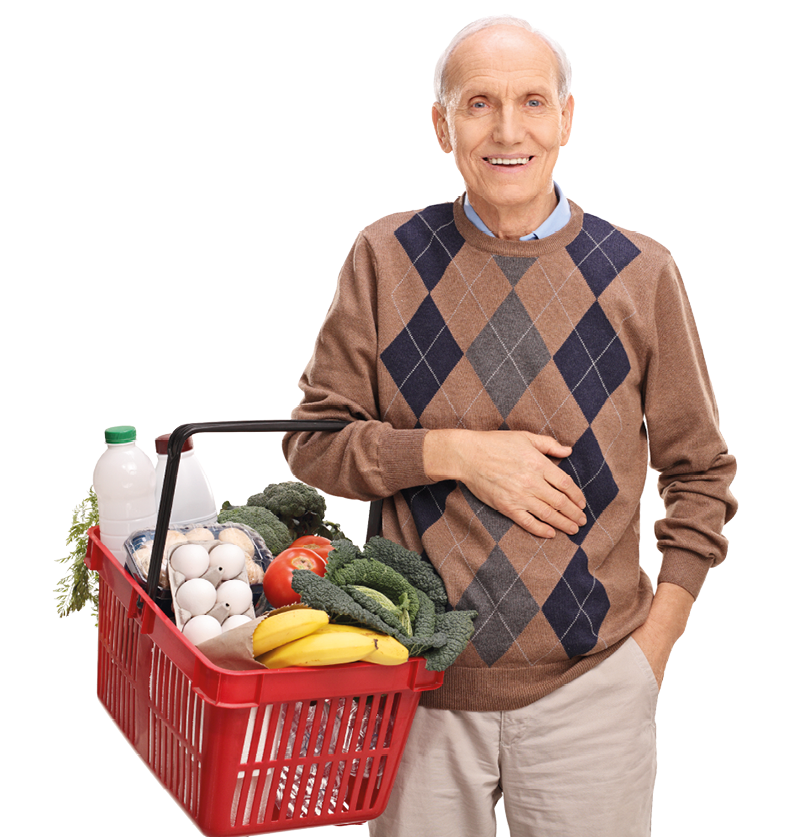 Cheerful senior gentleman holding a shopping basket full of groceries isolated on white background