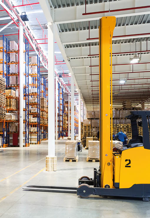 Large modern warehouse with forklifts