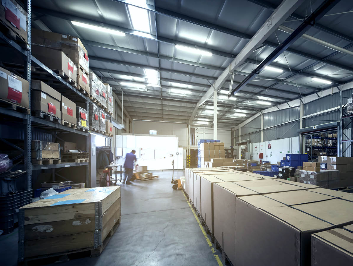 warehouse interior with paper boxes and worker with forklift in blue vintage color tone