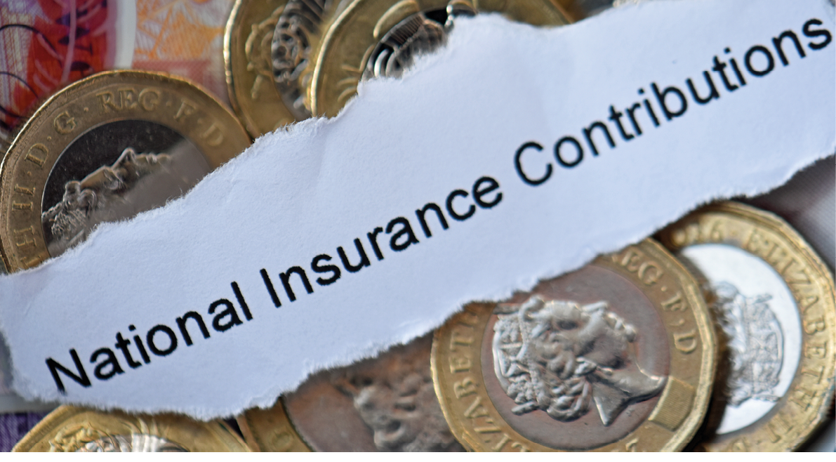 A torn piece of paper with the words National Insurance Contributions lies on top of scattered British pound coins. Description generated by AI