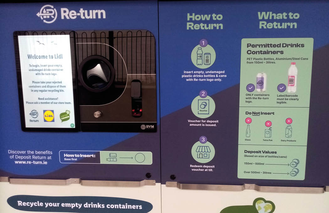 A recycling machine display explains how to return empty drink containers by inserting them to receive a deposit voucher and lists permitted drink containers and items not to insert. Description generated by AI
