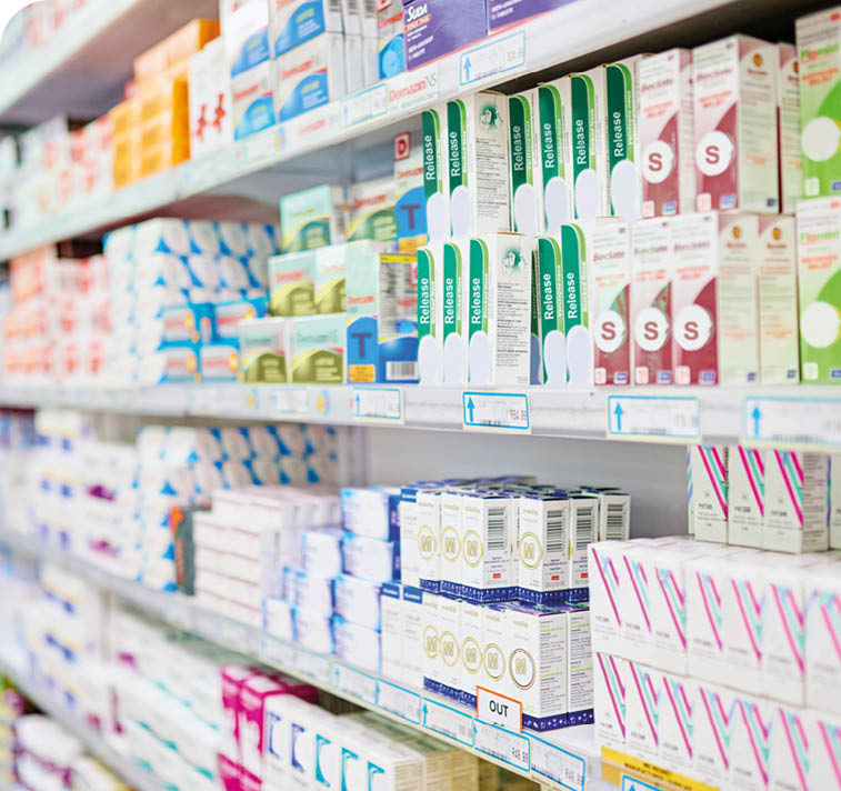 Shelves stocked with various boxed products arranged in rows inside a brightly lit store aisle. Description generated by AI