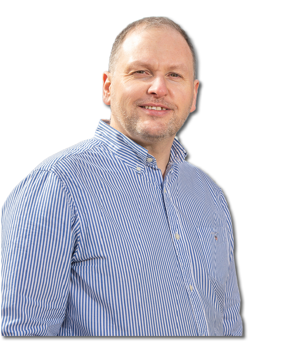 A person with short hair wearing a blue and white striped button-up shirt is smiling and looking slightly to the side against a white background. Description generated by AI