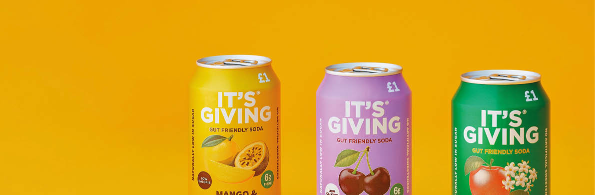 Three colorful cans of It’s Giving fruit-flavored soda in mango and passionfruit, black cherry, and apple and elderflower flavors are displayed against a yellow background. Description generated by AI
