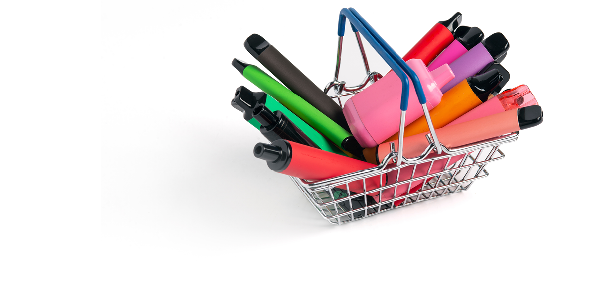 A small metal shopping basket filled with colorful vape pens arranged upright against a white background. Description generated by AI