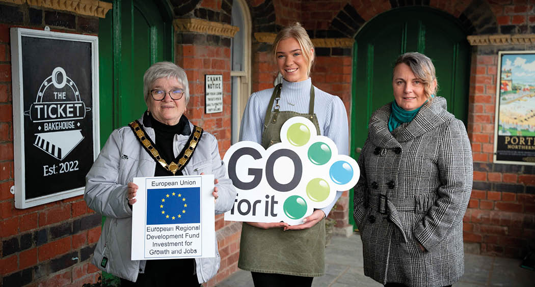Ballymena baker, Maia White has turned her passion for cakes and coffees into a thriving local caf , The Ticket Bakehouse in Cullybackey, thanks to the help from the Go For It programme in association with Mid and East Antrim Borough Council. Pictured (left to right) is, Deputy Mayor of Mid and East Antrim Borough Council, Councillor Beth Adger MBE, Maia White, Owner of The Ticket Bakehouse and Melanie Christie Boyle MBE, Chief Executive of Ballymena Business Centre. 